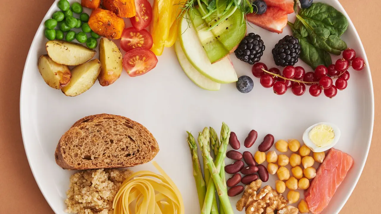 Flatlay of assorted nutritious whole foods — fruits, vegetables, nuts, and grains